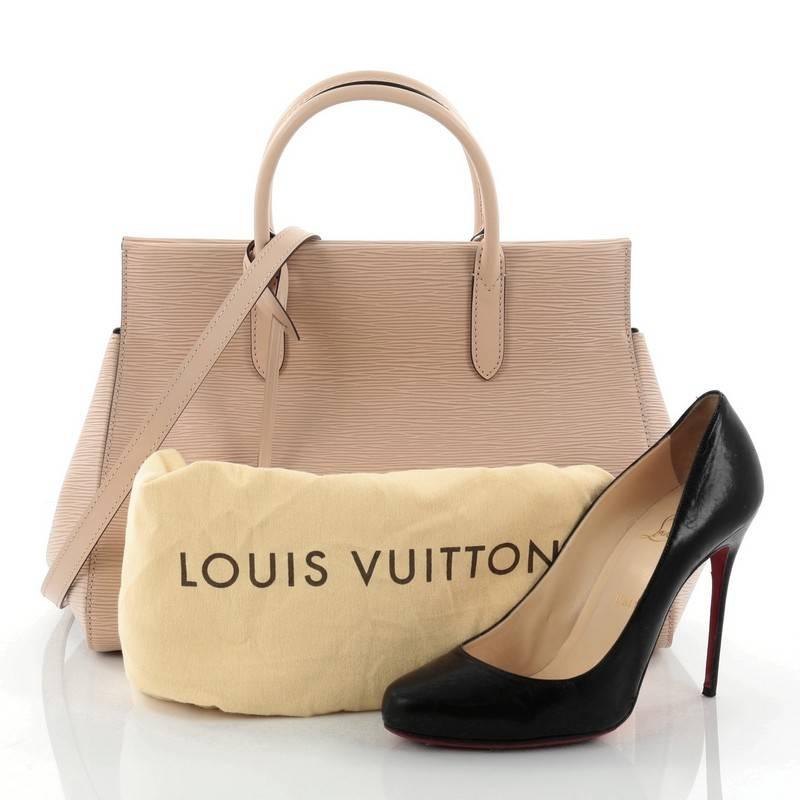 This authentic Louis Vuitton Marly Handbag Epi Leather MM exudes casual sophistication perfect for the modern woman. Crafted in sturdy nude epi leather, this structured working tote features an angular silhouette, dual-rolled leather handles, subtle