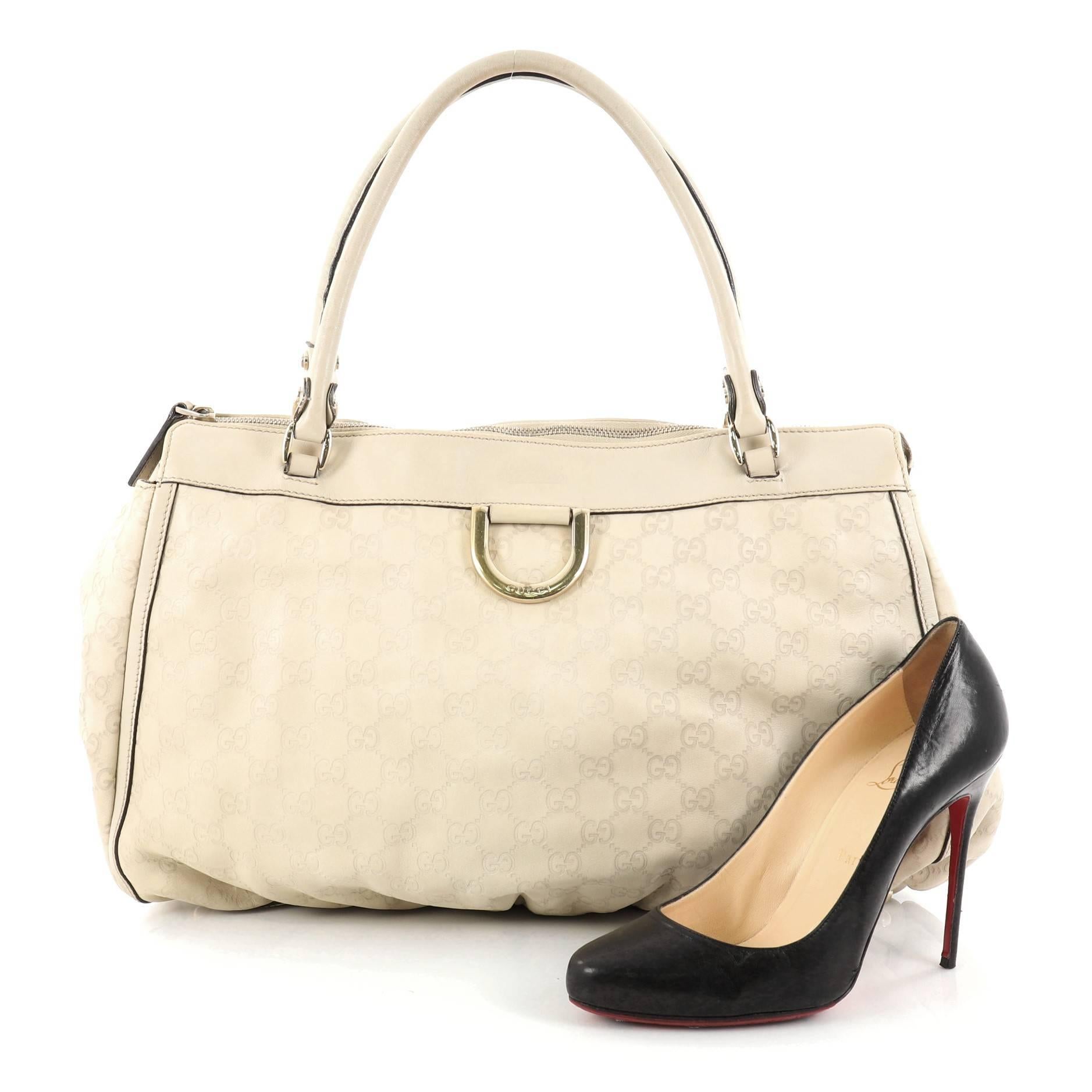 This authentic Gucci D Ring Tote Guccissima Leather Large is perfect for everyday use. Crafted from light beige guccissima leather, this tote features dual-rolled tall handles, light beige leather trims, Gucci handwritten stamped logo, signature D