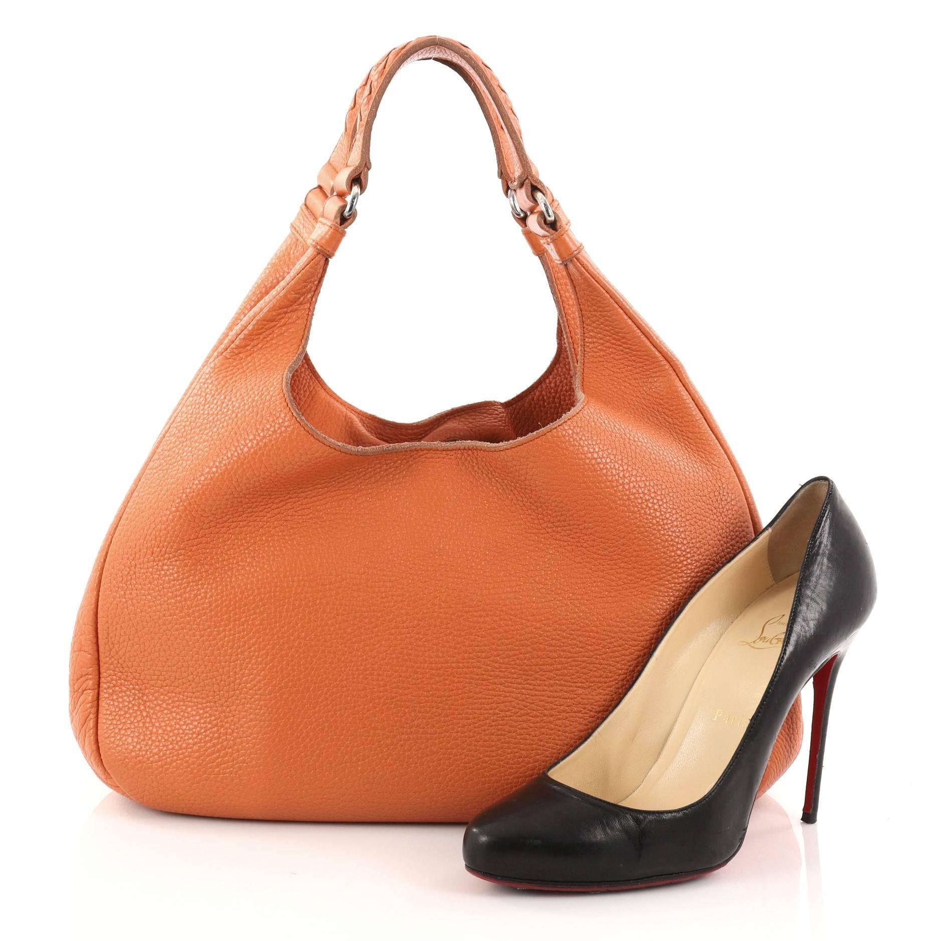 This authentic Bottega Veneta Campana Hobo Leather Small is both understated yet elegant perfect for the modern woman. Crafted from orange nappa leather, this functional shoulder bag features dual shoulder straps with silver-tone hardware accent and