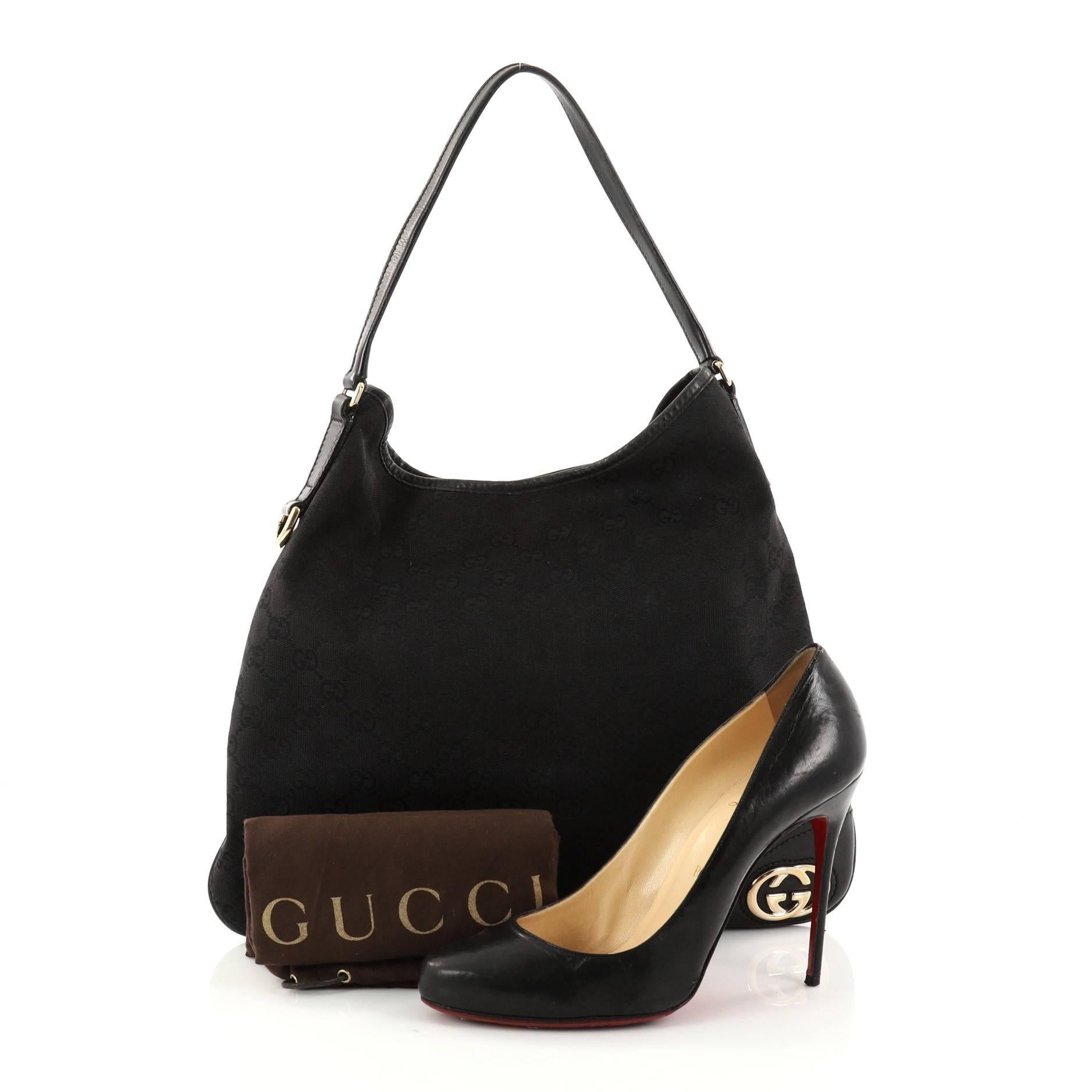 This authentic Gucci New Britt Hobo GG Canvas Medium is perfect for any casual or sophisticated outfit. Constructed from black GG canvas, this lightweight shoulder bag features a looping leather strap, black leather trims with GG interlocking logo