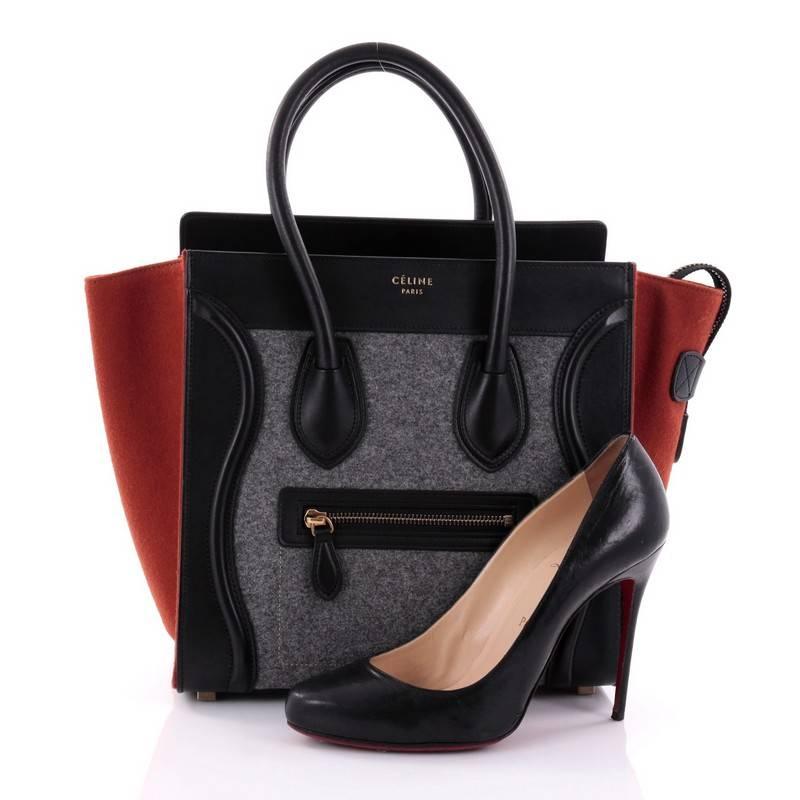 This authentic Celine Tricolor Luggage Handbag Felt Micro is one of the most sought-after bags beloved by fashionistas. Crafted from gray felt and black leather with burnt orange felt wings, this minimalist tote features dual-rolled handles, an