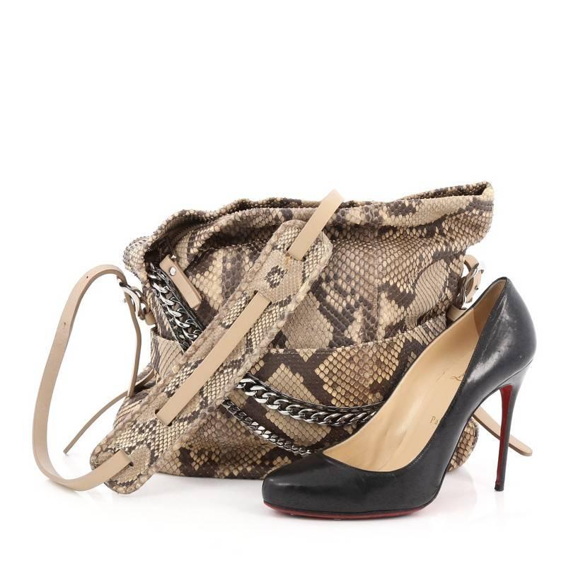 This authentic Jimmy Choo Boho Biker Hobo Python Small mixes casual-cool style with sartorial edge. Crafted from genuine brown python, this stylish hobo features a single strap, zip top fold over silhouette with a triad of draped chains, silver