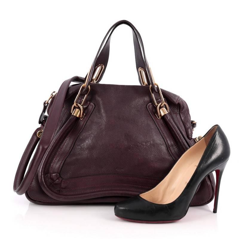 This authentic Chloe Paraty Top Handle Bag Leather Medium mixes everyday style and functionality perfect for the modern woman. Crafted from purple leather, this versatile bag features dual flat handles, piped trim details, side twist locks, and