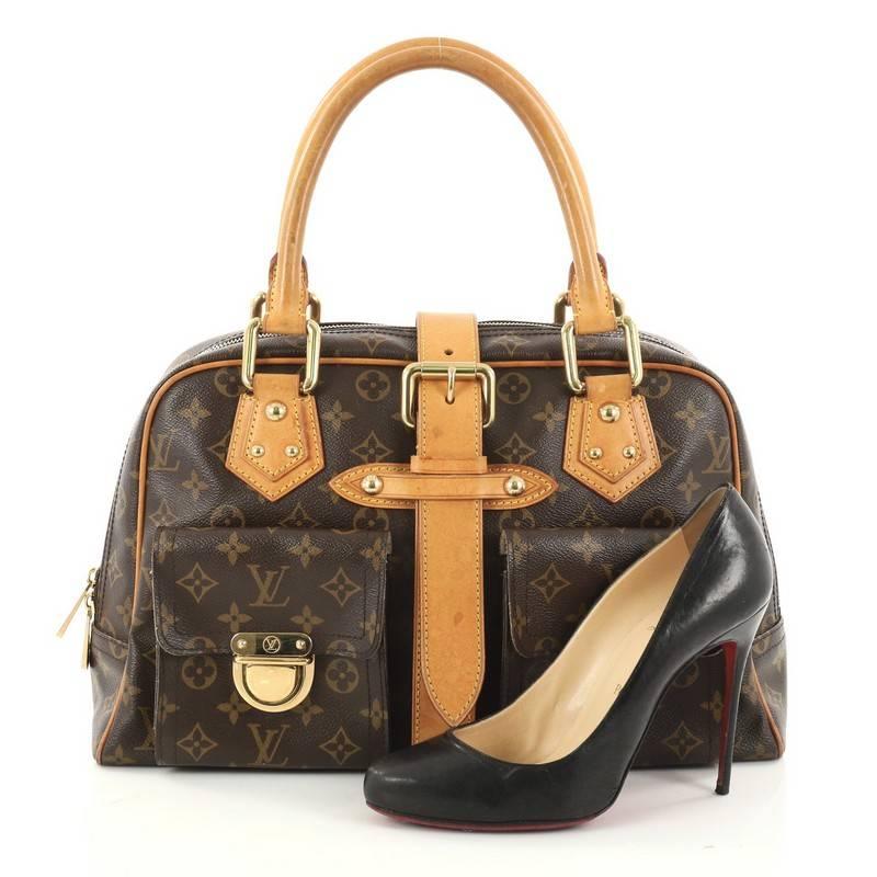 This authentic Louis Vuitton Manhattan Handbag Monogram Canvas GM combines style and functionality apt for the modern day woman. Constructed in Louis Vuitton's signature brown monogram coated canvas, this classic satchel features dual-rolled