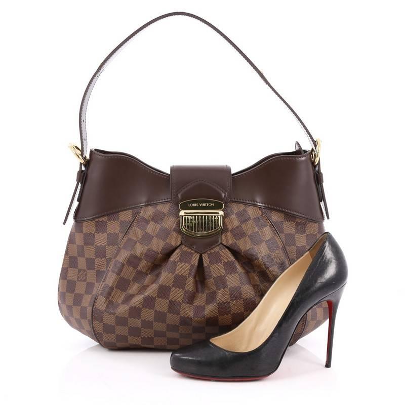 This authentic Louis Vuitton Sistina Handbag Damier MM is perfect for everyday use. Crafted from damier ebene coated canvas, this stylish, feminine bag features center pleating, smooth brown leather trims, flat buckle shoulder straps, and gold-tone