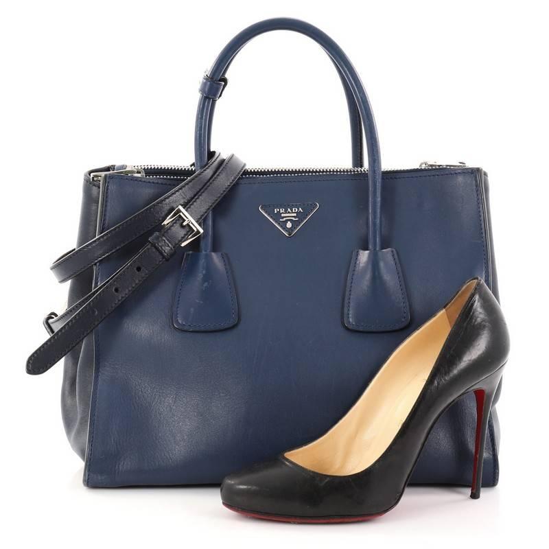 This authentic Prada Twin Pocket Tote City Calfskin Medium showcases a modern silhouette perfect for today's woman. Crafted from blue calfskin leather, this stylish and functional tote features dual-rolled handles, expanded winged sides, raised
