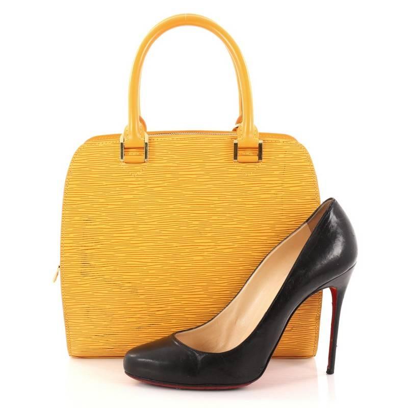 This authentic Louis Vuitton Pont Neuf Handbag Epi Leather PM is a classic must-have handle bag. Constructed in yellow epi leather, this sturdy handle bag showcases dual-rolled leather handles, slip compartments at the front and back, a subtle