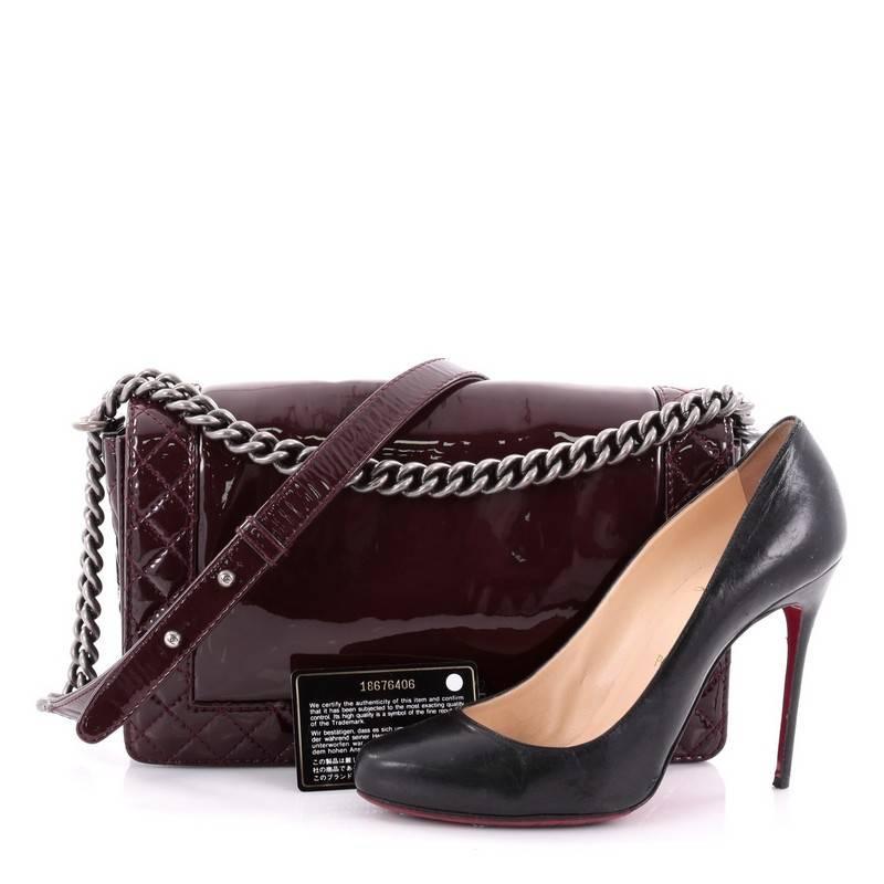 This authentic Chanel Reverso Boy Flap Bag Patent New Medium is every woman’s dream. Crafted in luxurious maroon patent leather with quilted stitched on edges, this popular bag features chain link straps with leather pads, iconic CC logo with boy