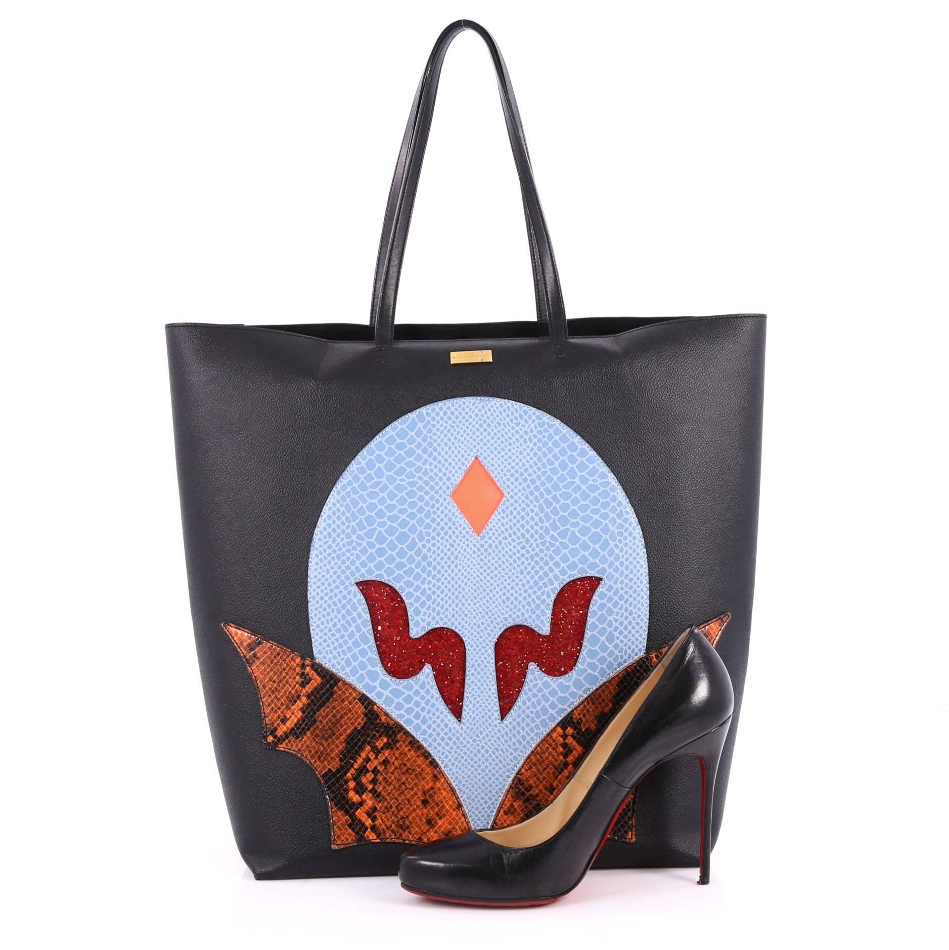 This authentic Stella McCartney Super Hero Tote Faux Leather, from the brands' Resort 2015 Collection, is a fashion-forward bag made for on-the-go moments. Crafted in black faux leather, this unique tote features dual-thin leather handles, super