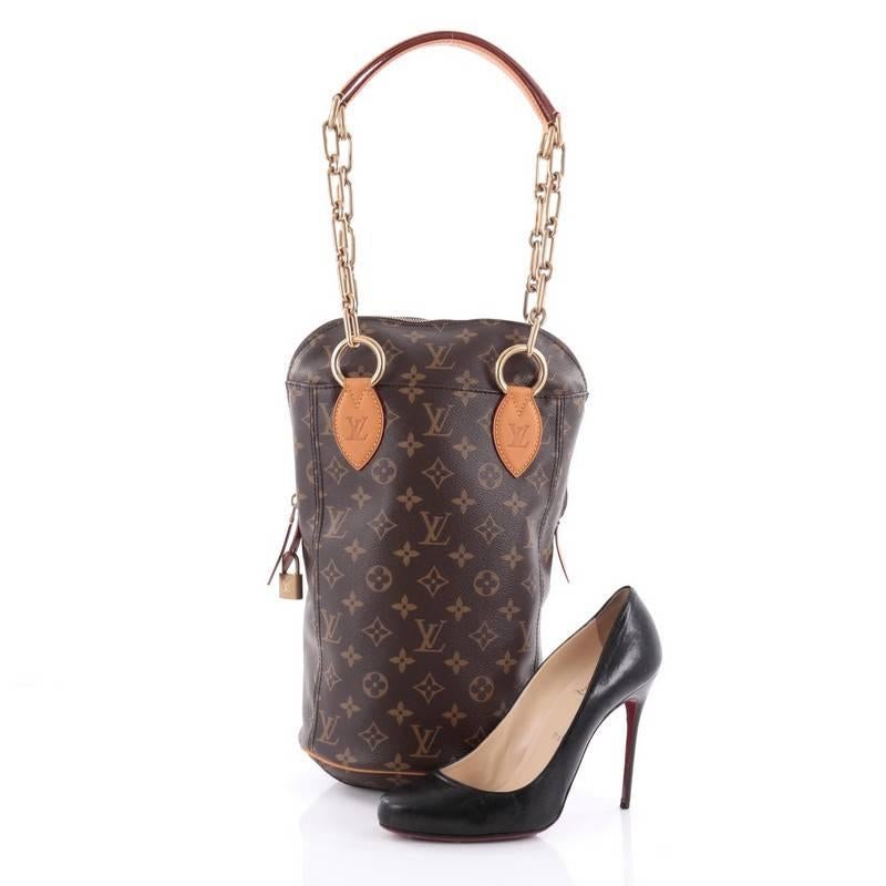 This authentic Louis Vuitton Punching Bag Monogram Canvas Baby is a collaboration piece from Karl Lagerfeld, Rei Kawakubo, Marc Newsom, Cindy Sherman, Frank Gehry, and Christian Louboutin that combines the concepts of sport and luxury. Crafted from