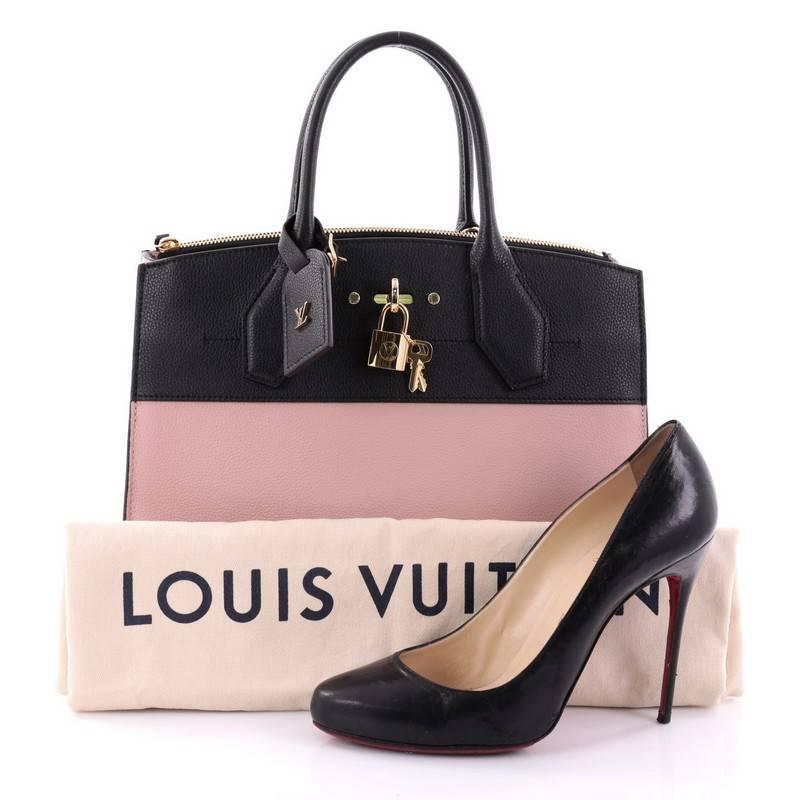 This authentic Louis Vuitton City Steamer Handbag Leather MM designed by Nicholas Ghesquiere is an elegant structured bag made for everyday use. Crafted in light pink and black leather, this modern day tote features dual-rolled leather handles,