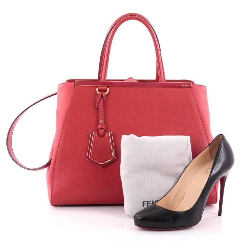 This authentic Fendi 2Jours Handbag Leather Medium is impeccably stylish with a simple silhouette and structured design. Finely crafted in sturdy red leather with soft calfskin sides, this popular tote features a shining top bar that dons the Fendi