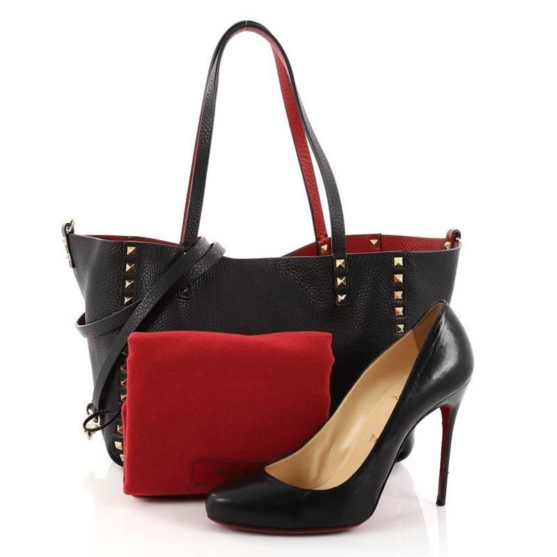 This authentic Valentino Rockstud Reversible Convertible Tote Leather Small is the perfect daily bag for on-the-go fashionista. Crafted from red and black leather, this tote features the brand's iconic pyramid rockstud detailing, dual tall flat