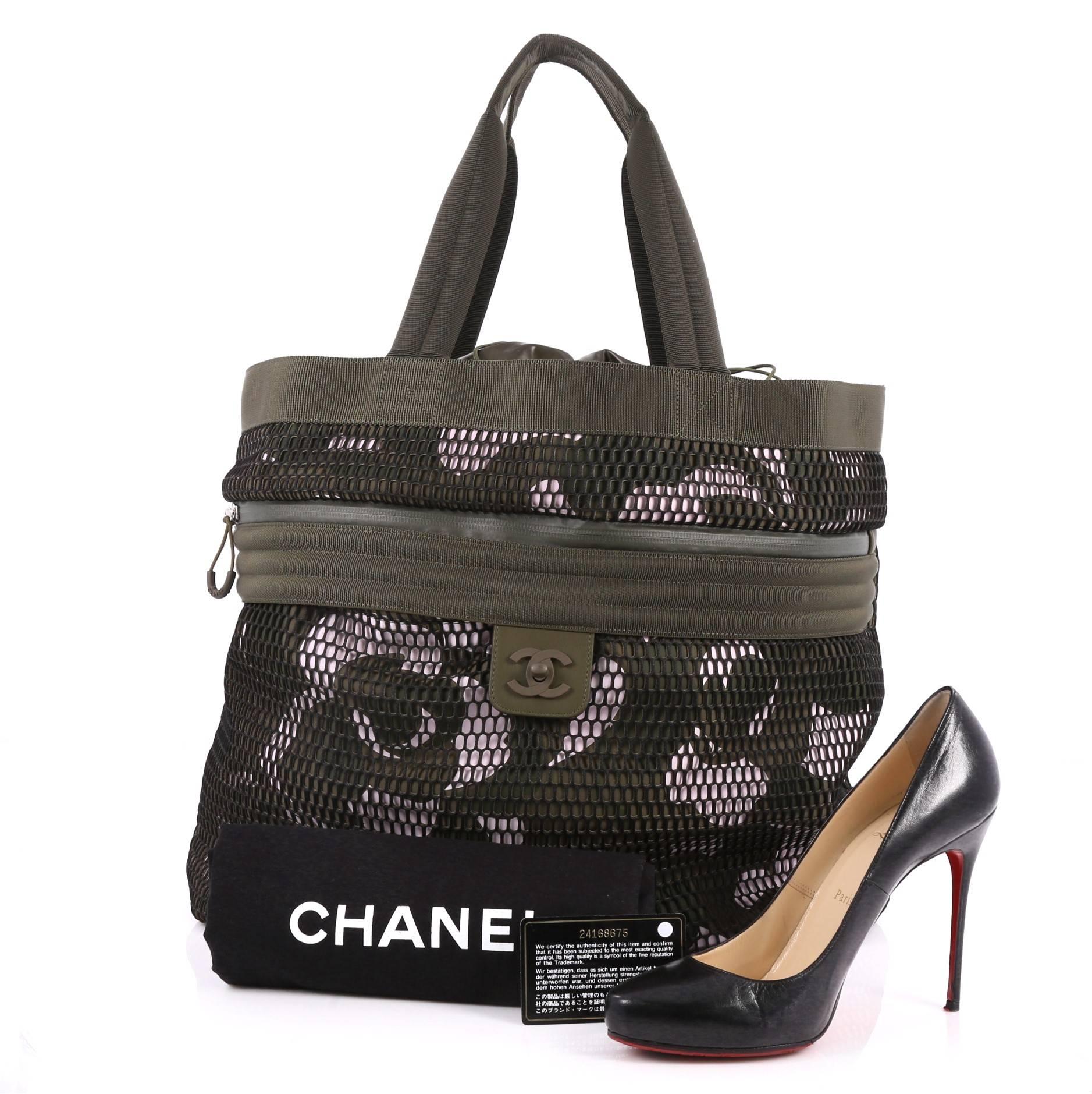 This authentic Chanel Sporty Shopping Tote Printed Neoprene with Mesh Large is from the bags Pre-Collection Spring 2017. Crafted in olive green printed neoprene with mesh, this bag features dual top handles, exterior zip pocket, exterior slip pocket
