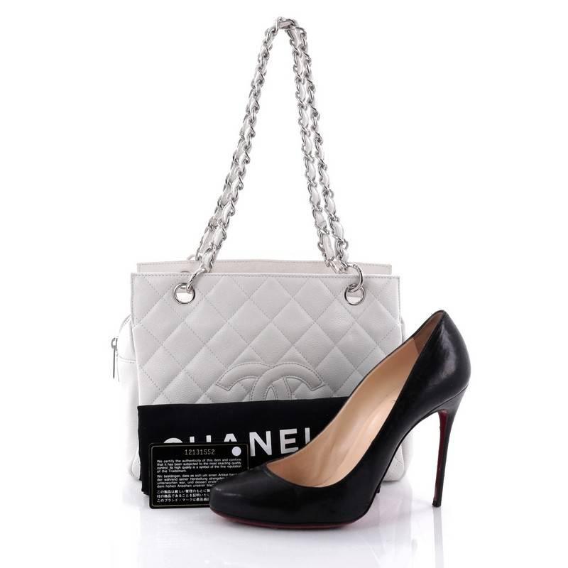 This authentic Chanel Petite Timeless Tote Quilted Caviar is perfect for everyday use with a classic yet luxurious style. Crafted in white diamond quilted caviar leather, this versatile, timeless tote features a stitched CC in the middle, woven-in