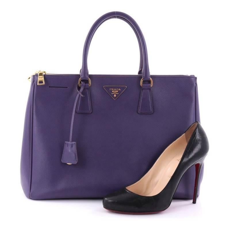 This authentic Prada Double Zip Lux Tote Saffiano Leather Large is the perfect bag to complete any outfit. Crafted from purple saffiano leather, this boxy tote features side snap buttons, raised Prada logo plate, dual-rolled leather handles and