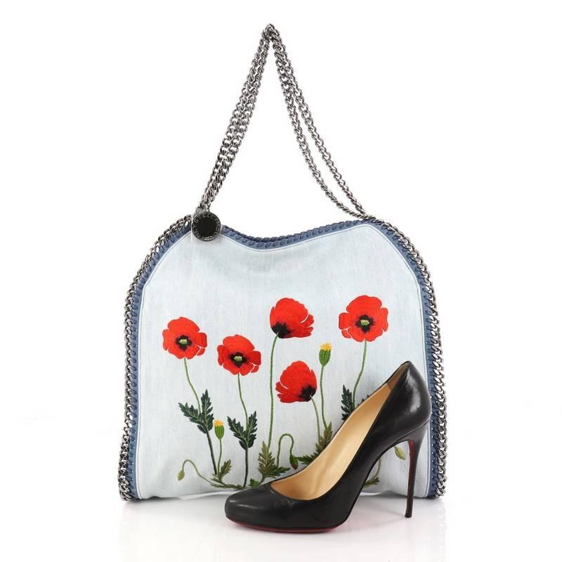 This authentic Stella McCartney Falabella Tote Embroidered Denim Small is perfect for casual day-to-day excursions. Crafted from blue floral embroidered denim, this no-fuss, lightweight tote features gunmetal chain link strap and trims, whipstitched
