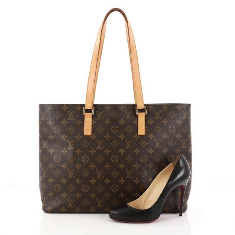 This authentic Louis Vuitton Luco Handbag Monogram Canvas is a classic tote that displays fashion and functionality all rolled into one. Crafted with the brand's iconic brown monogram coated canvas, this tote features dual flat leather handles, a