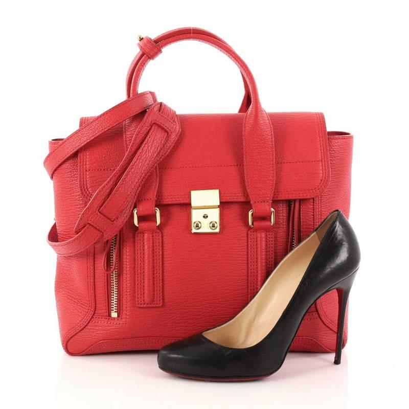 This authentic 3.1 Phillip Lim Pashli Satchel Leather Medium is a practical bag with a stylish edge made for on-the-go moments. Crafted from red leather, this chic satchel features dual top handles, expandable zip sides, top flap push-lock closure