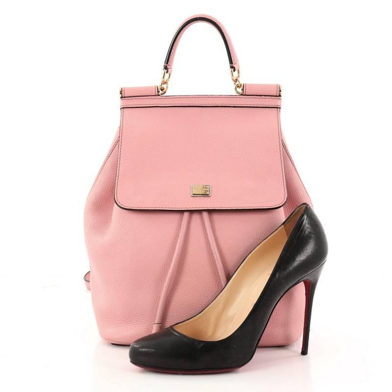 This authentic Dolce & Gabbana Miss Sicily Backpack Leather Mini pays homage to the designers' Sicilian heritage with a fresh twist. Crafted from pink leather, this backpack features leather top handle, adjustable shoulder strap, designer plaque,
