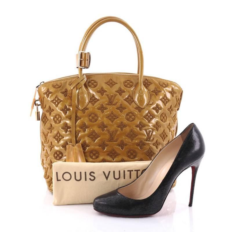 This authentic Louis Vuitton Fascination Lockit Handbag Patent Lambskin presented in the brand's Fall/Winter 2011 Collection is perfect for nights out. Crafted in yellow patent leather embroidered with LV's iconic monogram bouclette design, this