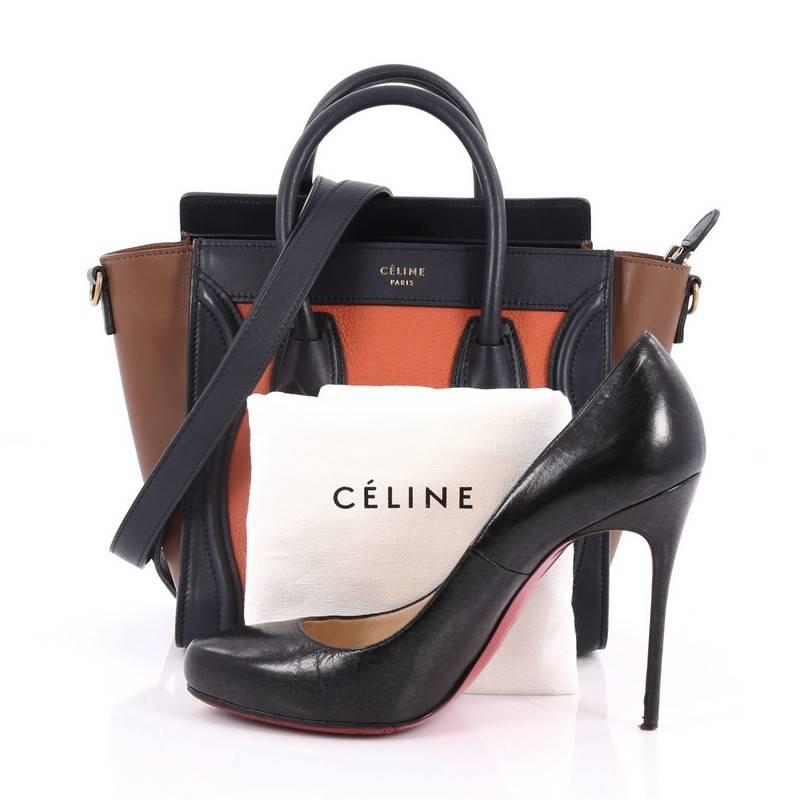 This authentic Celine Tricolor Luggage Handbag Leather Nano showcases an elegant day-to-day style essential for any fashionista. Constructed with navy and orange leather with brown wings, this popular tote features a frontal zip pocket, dual-rolled