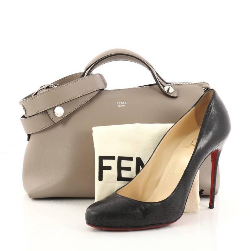 This authentic Fendi By The Way Satchel Calfskin Small showcases a modern style admired by every fashionista. Constructed from taupe calfskin leather, this minimalist and functional duffle features dual flat leather top handles, stamped Fendi foil