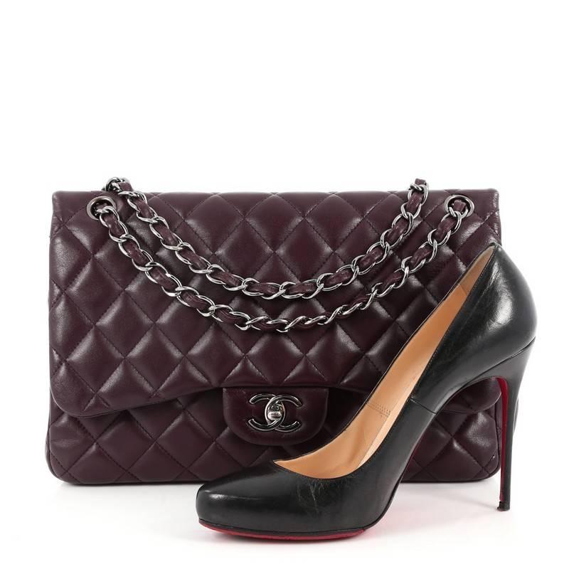This authentic Chanel Classic Double Flap Bag Quilted Lambskin Jumbo exudes a classic yet easy style made for the modern woman. Crafted from purple lambskin leather, this elegant flap bag features Chanel's signature diamond quilted design, woven-in