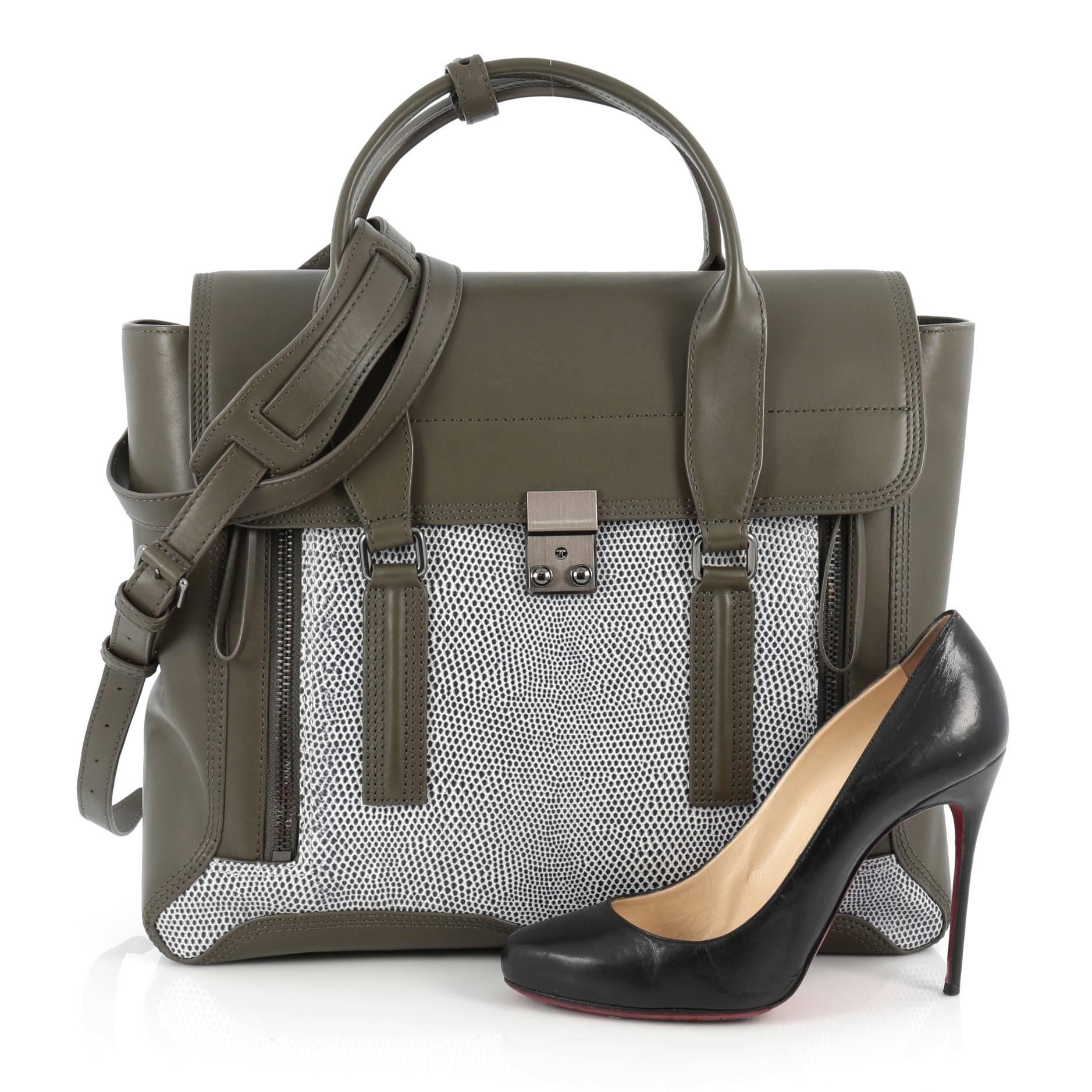 This authentic 3.1 Phillip Lim Pashli Satchel Lizard Embossed and Leather Large is a practical bag with a stylish edge made for on-the-go moments. Crafted from khaki green and blue and white lizard embossed leather, this chic satchel features dual