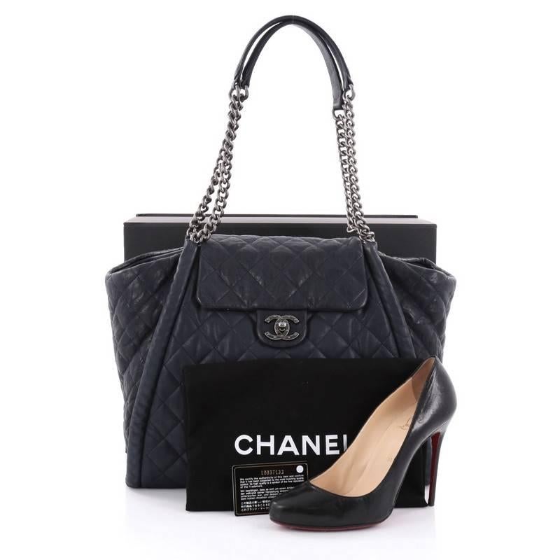This authentic Chanel Studded CC Flap Tote Quilted Calfskin Large from the brand's 2014 Collection is an eye-catching style fit for the modern woman. Crafted in lighter and darker blue quilted calfskin leather, this oversized chic tote features a