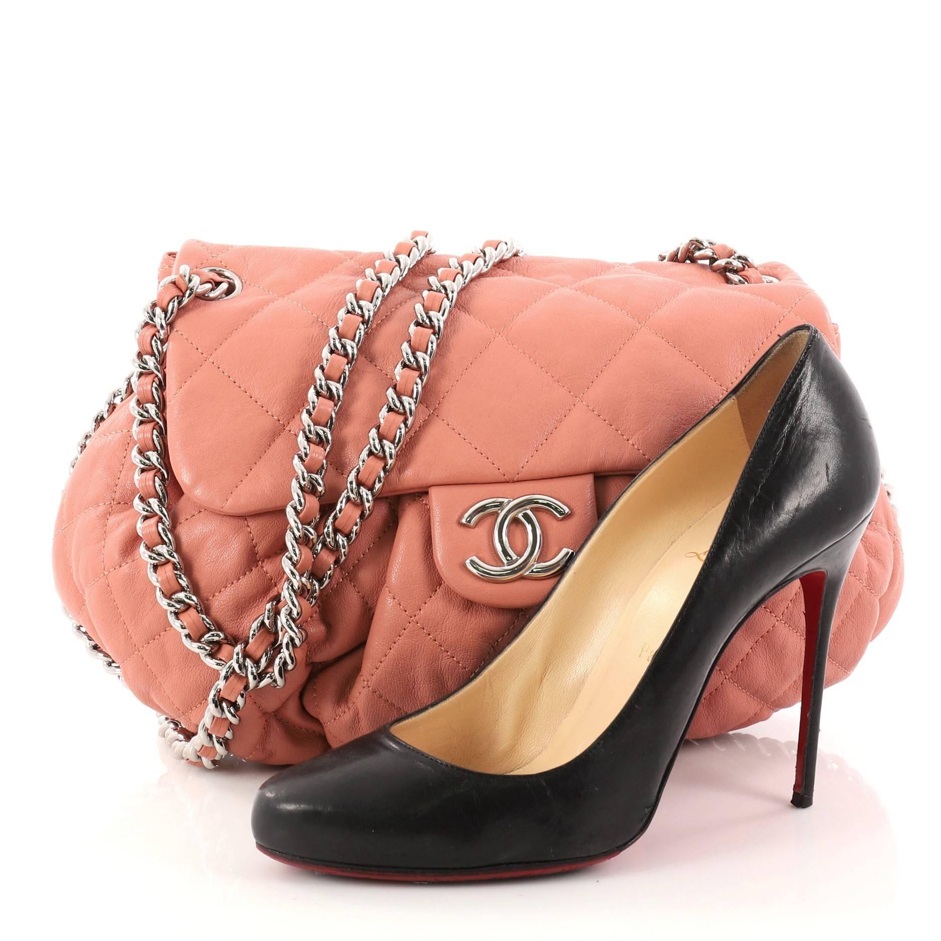 This authentic Chanel Chain Around Flap Bag Quilted Leather Medium is a beautiful addition to your collection. Crafted in rose quilted leather, this soft pleated flap bag features woven-in leather chain strap, chain-around design, frontal flap with