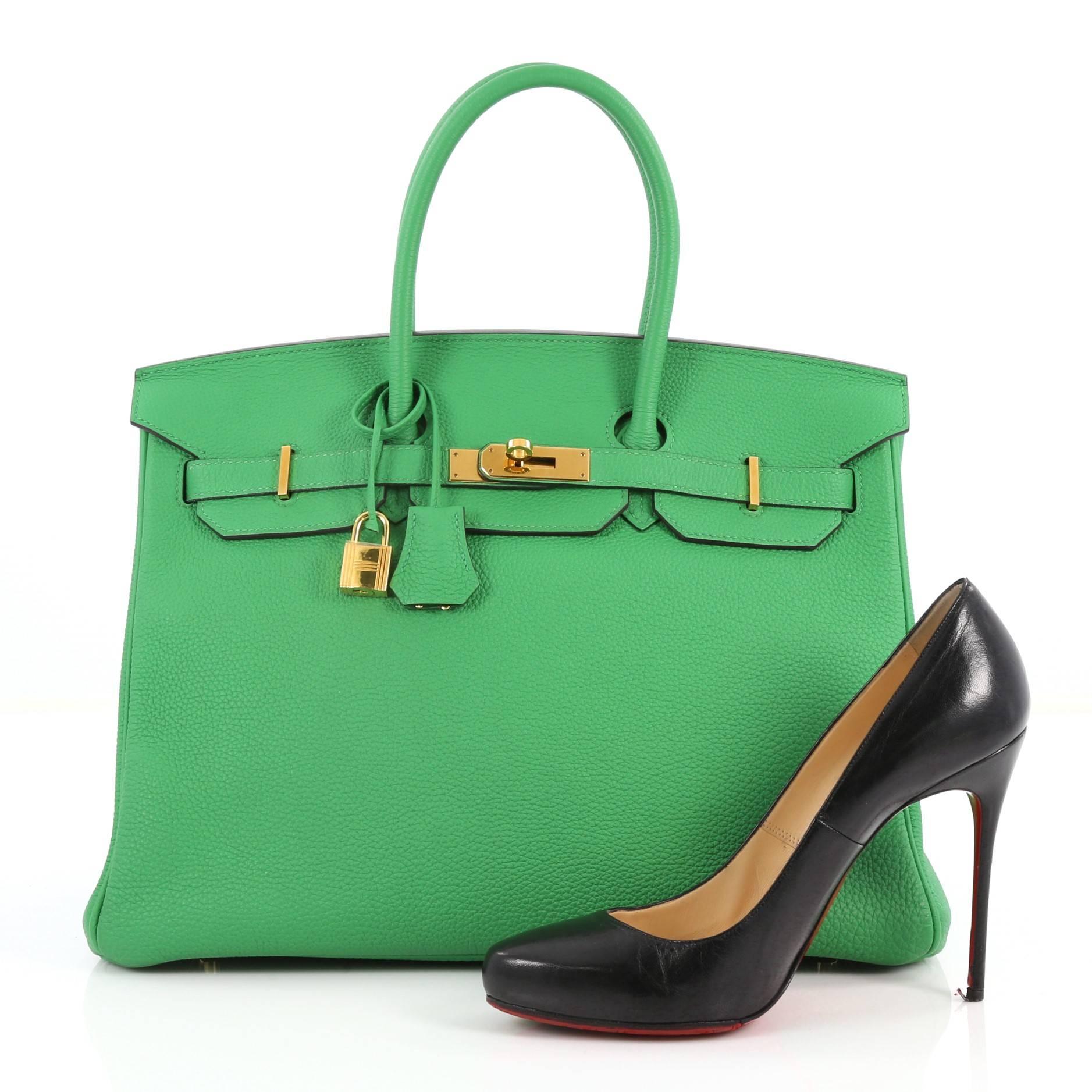 This authentic Hermes Birkin Handbag Bamboo Togo with Gold Hardware 35 stands as one of the most-coveted and timeless bags fit for any fashionista. Constructed from scratch-resistant bamboo green togo leather, this subtly sleek tote features