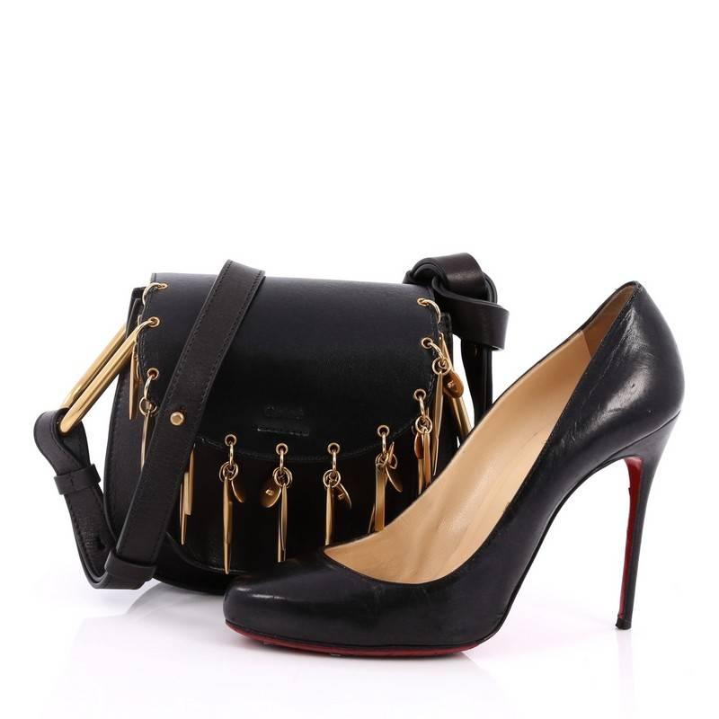 This authentic Chloe Charm Hudson Leather Mini is a softly structured Hudson bag that gets a luxuriously bohemian update to its Parisian-chic roots. Crafted from black leather, this chic bag features adjustable shoulder strap with U-shaped rings,