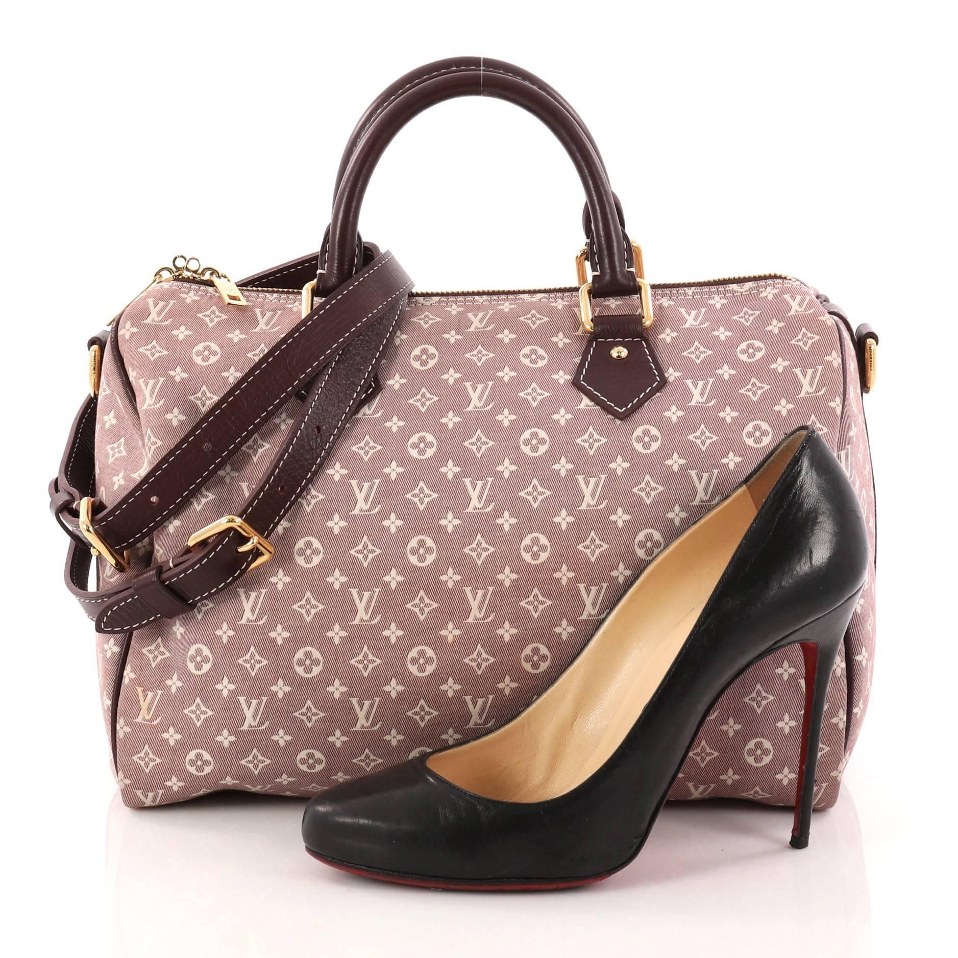 This authentic Louis Vuitton Speedy Bandouliere Bag Monogram Idylle 30 is a classic must-have. Constructed from Louis Vuitton's burgundy idylle monogram canvas, this fresh Speedy features dual rolled top handles, leather trims, and gold-tone