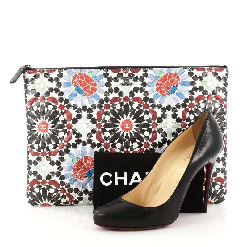 This authentic Chanel Dubai O Case Clutch Quilted Printed Lambskin Large is from the brand's Cruise 2014 Collection presented in Dubai. Crafted in multicolor printed lambskin leather, this stylish clutch features an abstract kaleidoscope print