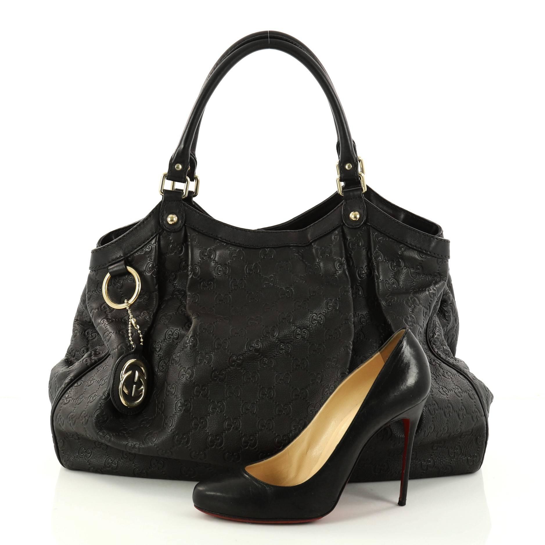 This authentic Gucci Sukey Tote Guccissima Leather Large is a chic tote ideal for your everyday wear. Crafted from black GG monogram guccissima leather, this pleated tote features dual-rolled leather top handles, side snap buttons, and gold-tone