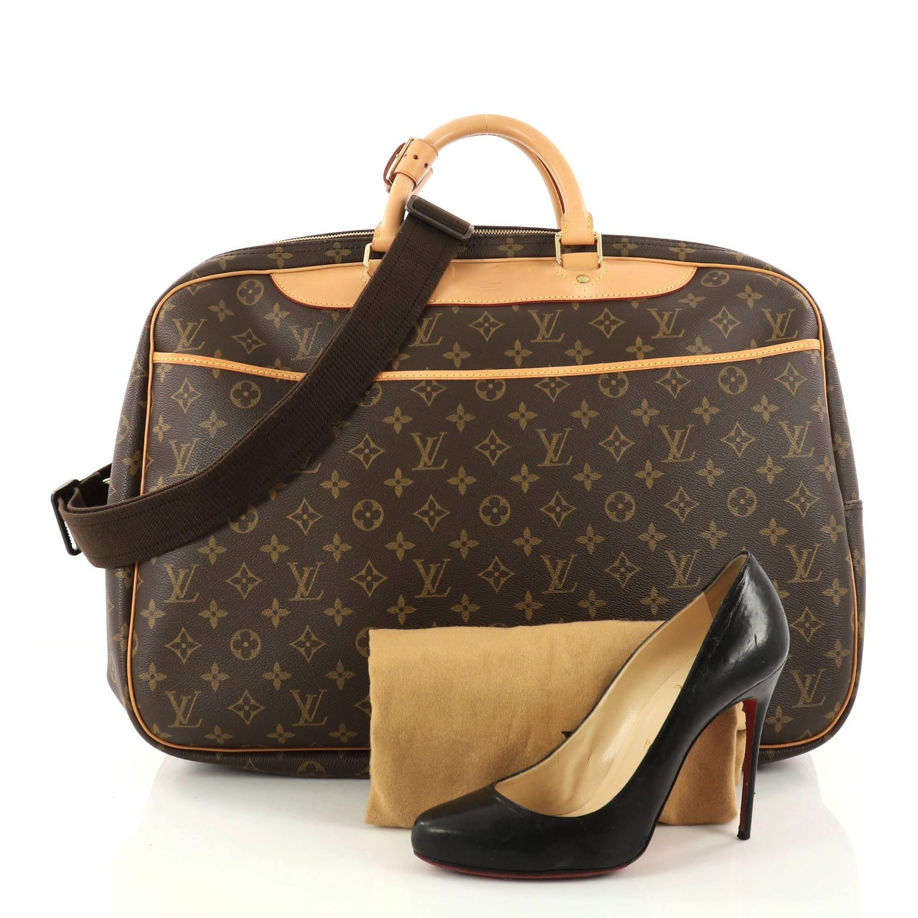 This authentic Louis Vuitton Alize Bag Monogram Canvas 2 Poches is your luxurious companion made for travels and weekend getaways. Crafted in Louis Vuitton's iconic brown monogram coated canvas with vachetta handles and trims, this soft suitcase