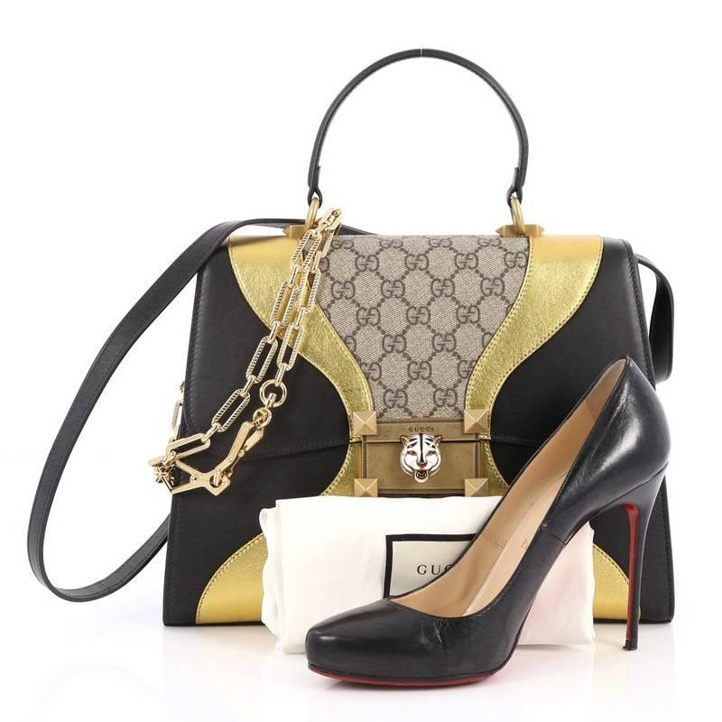 This authentic Gucci Osiride Top Handle Bag GG Canvas and Leather Medium is a gorgeous bag perfect for your days or nights out. Crafted in brown GG supreme coated canvas with black and gold leather, this stylish bag features a flat top handle,