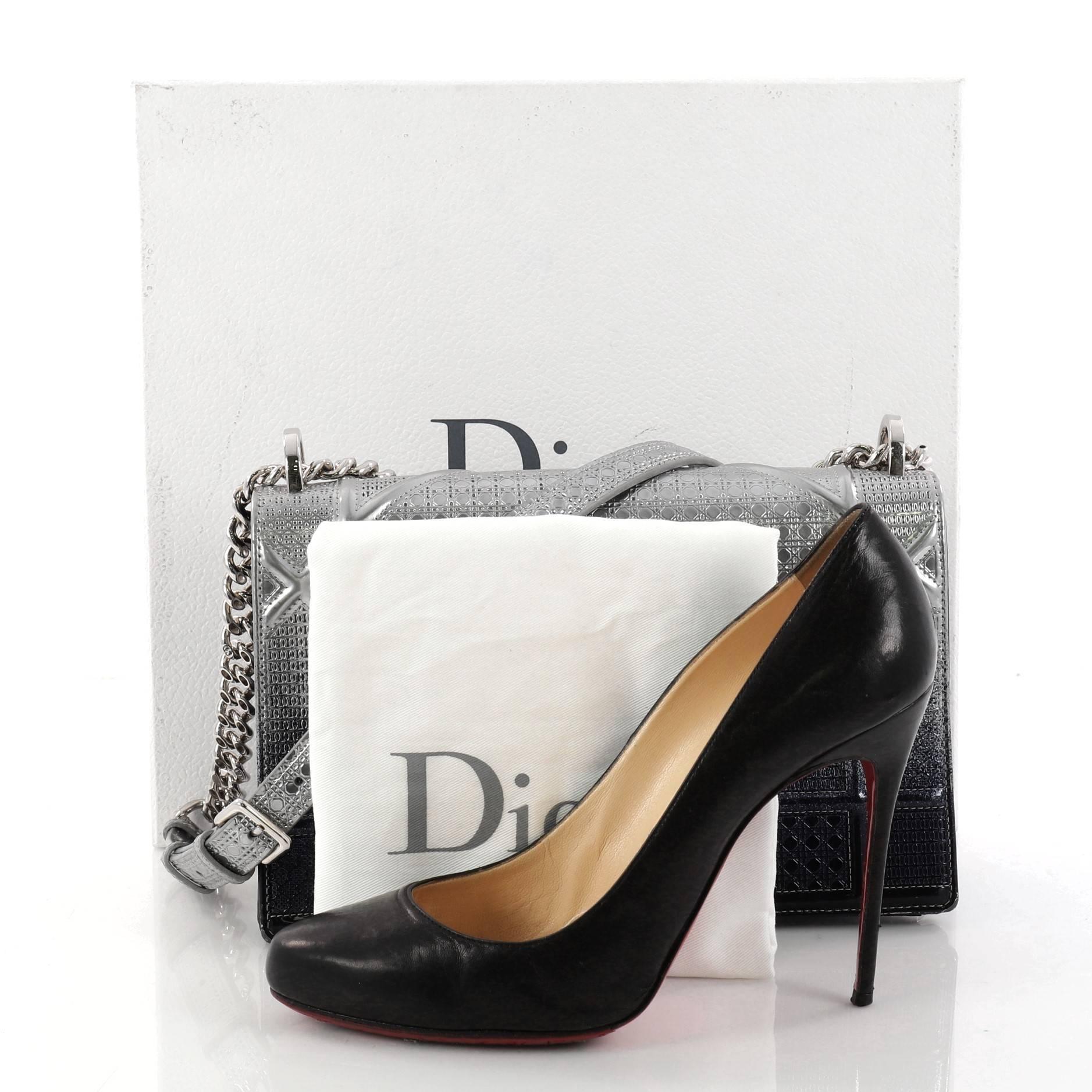 This authentic Christian Dior Diorama Flap Bag Ombre Cannage Embossed Calfskin Medium is a stylish bag that showcases its traditional design with a structured, modern flair. Crafted in sleek silver and blue ombre cannage embossed calfskin, this
