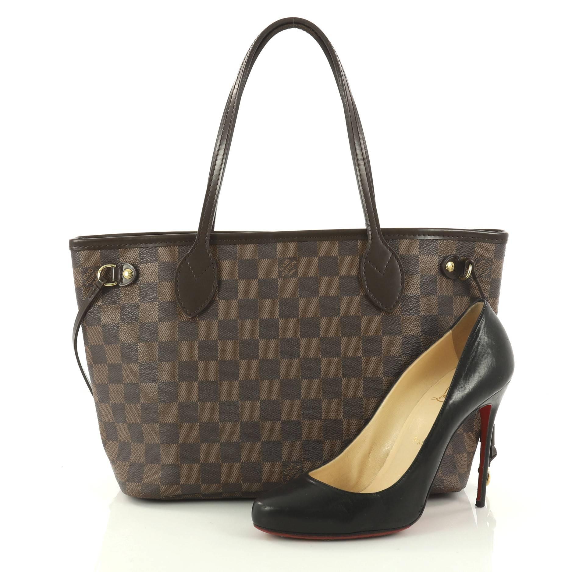 This authentic Louis Vuitton Neverfull Tote Damier PM is a popular and practical tote beloved by many. Constructed with Louis Vuitton's signature damier ebene coated canvas, this tote is spacious and structured without being bulky. The side laces