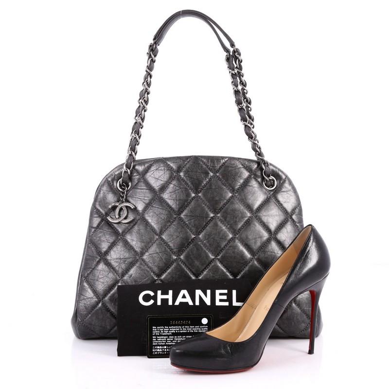 This authentic Chanel Just Mademoiselle Handbag Quilted Aged Calfskin Large complements any look. Crafted from dark grey aged calfskin leather in Chanel's iconic diamond stitch pattern, this timeless bag features woven-in leather chain straps with