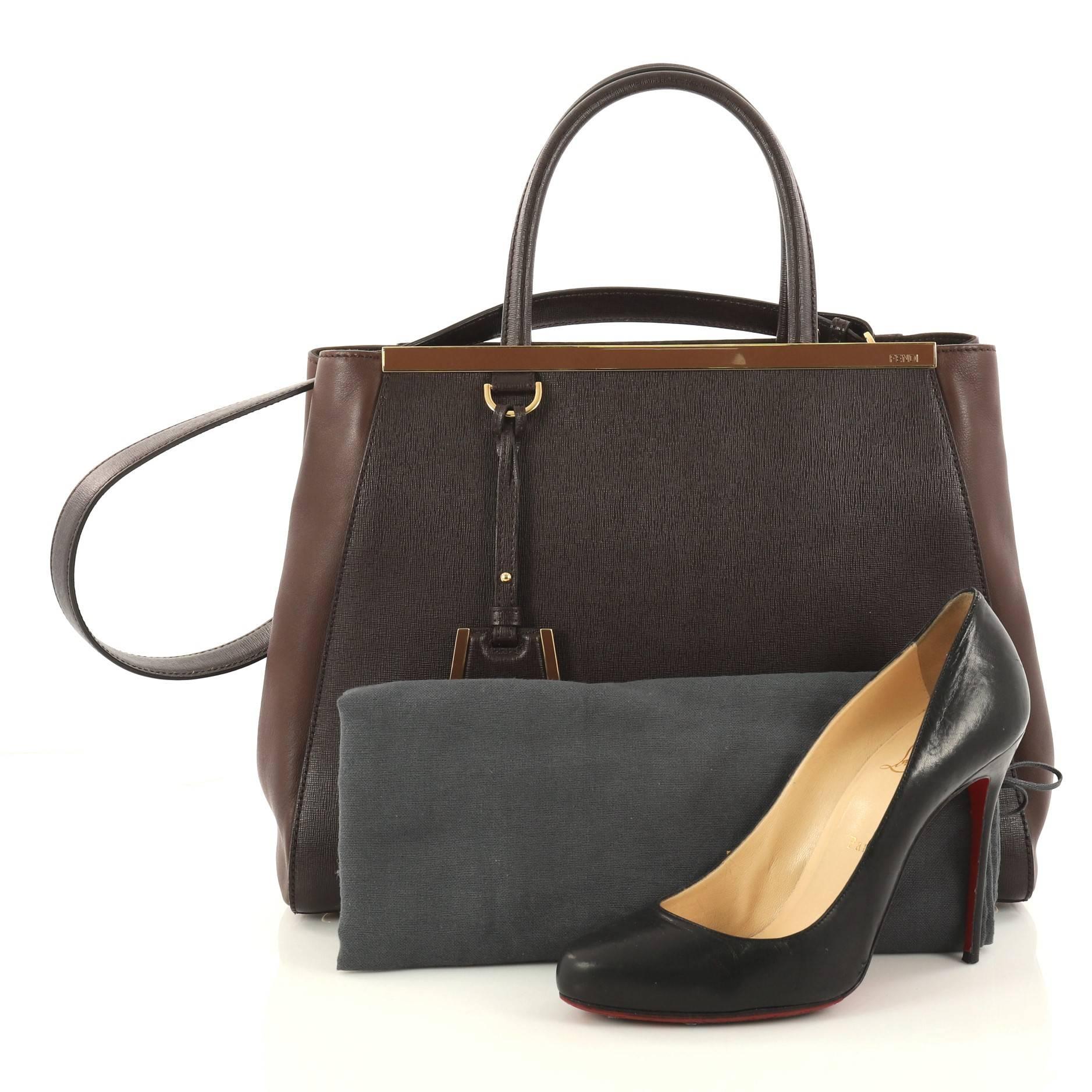 This authentic Fendi 2Jours Handbag Leather Medium is impeccably stylish with a simple silhouette and structured design. Finely crafted in sturdy brown leather with soft calfskin sides, this popular tote features a shining top bar, protective base