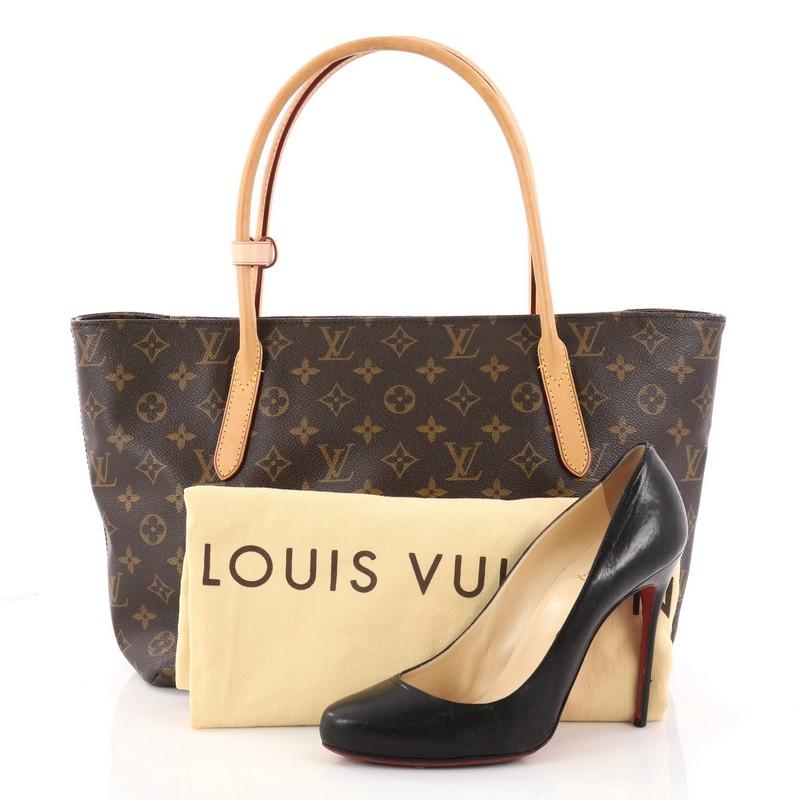 This authentic Louis Vuitton Raspail Tote Monogram Canvas PM is a simple classic style with modern functionality. Crafted from brown monogram coated canvas, this stylish tote features dual-rolled vachetta leather handles, and gold-tone hardware