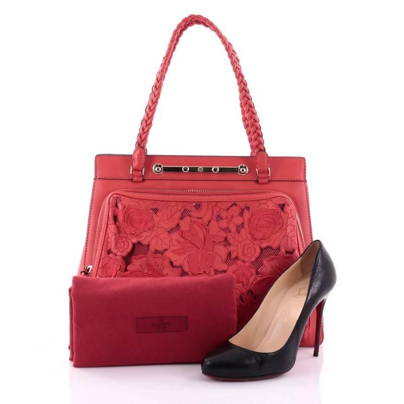 This authentic Valentino Demetra Tote Leather Lace showcases a chic and stylish design made for day-to-day excursions. Crafted in red leather, this romantic, feminine tote features braided leather straps, a large front zip-around pocket with braided