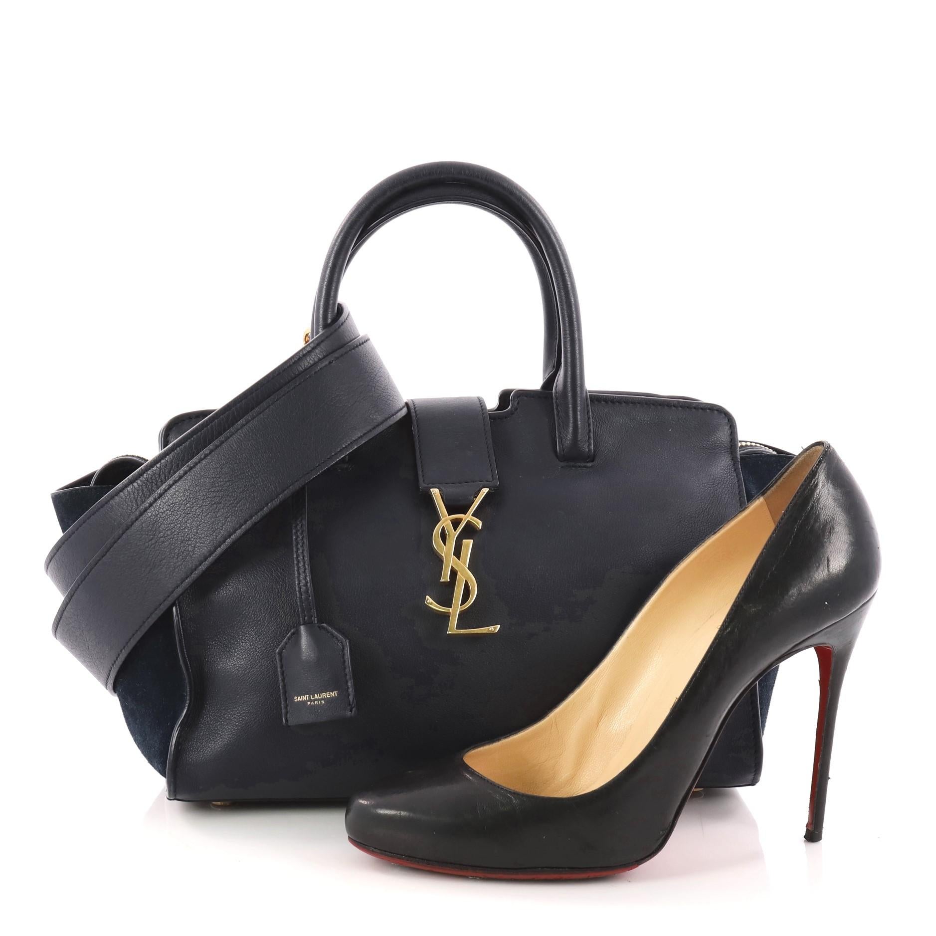 This authentic Saint Laurent Monogram Cabas Downtown Leather Baby combines a modern and functional style with an edgy twist. Crafted from navy leather and suede, this boxy satchel features dual-rolled handles, YSL metal logo at the front, protective
