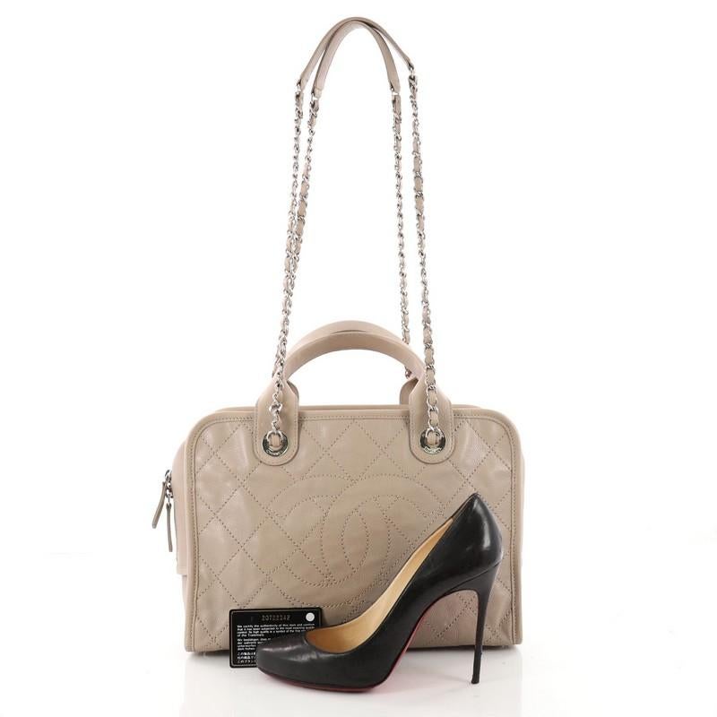 This authentic Chanel Deauville Bowling Bag Quilted Caviar Large embodies a casual chic style made for any fashionista. Crafted in taupe quilted caviar leather, this chic satchel features dual-rolled top leather handles, dual woven-in leather chain