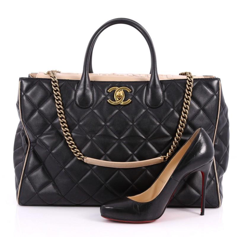 This authentic Chanel Portobello Logo Tote Quilted Lambskin Large is a luxurious bag that is perfect for carrying to work and everyday use. Crafted from black quilted lambskin leather, this bag features dual-rolled leather handles, chain-link straps