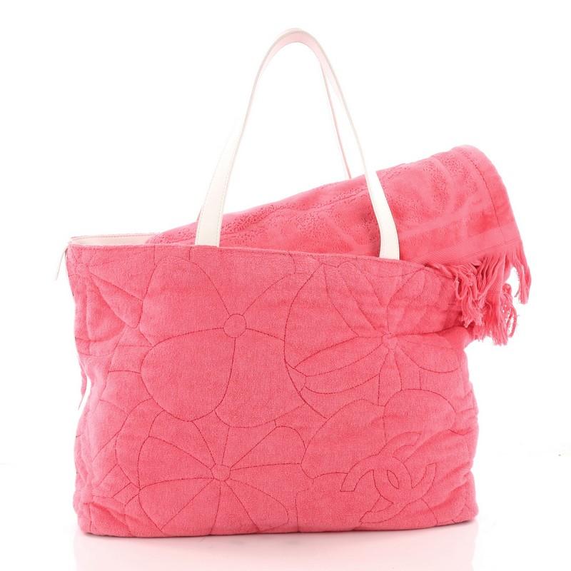 This authentic Chanel Beach Tote Camellia Terry Cloth Large is the perfect accessory for a casual day out. Crafted from camellia embossed pink terry cloth, this lightweight beach tote features dual-flat handles, and white leather trims. It opens to
