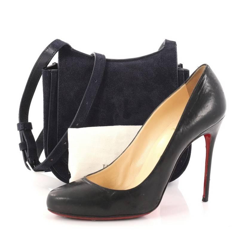 This authentic The Row Hunting Crossbody Bag Suede 7 is a sleek and minimalist bag ideal for everyday use. Crafted in navy blue suede, this saddle-style crossbody bag features an adjustable leather strap, back slip pocket and silver-tone hardware