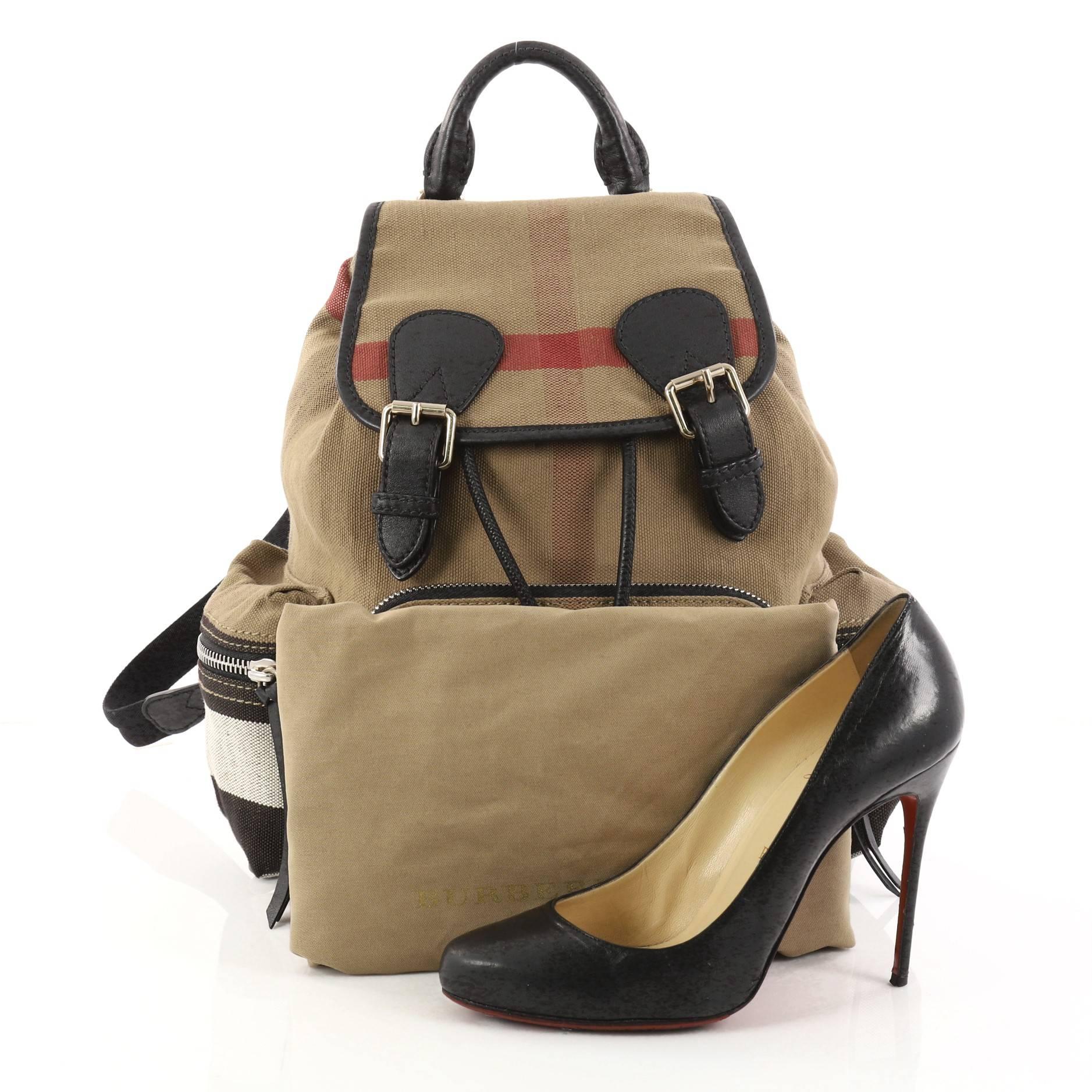 This authentic Burberry Rucksack Backpack House Check Canvas Medium is a bag that pulls off a look that's utterly utilitarian and still effortlessly cool. Crafted from house check canvas, this backpack features a leather top handle, adjustable